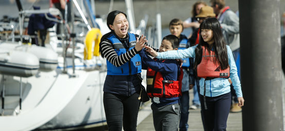 	An image of smiling faces of a young women with two children