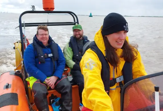 Three people on a Humber Rescue Service rigid inflatable boat (RIB)