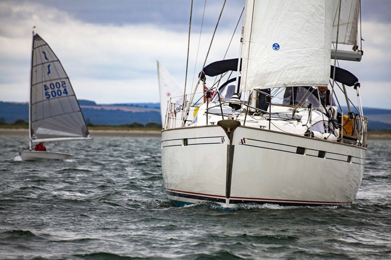 mid shot of yacht sailing with trainees 