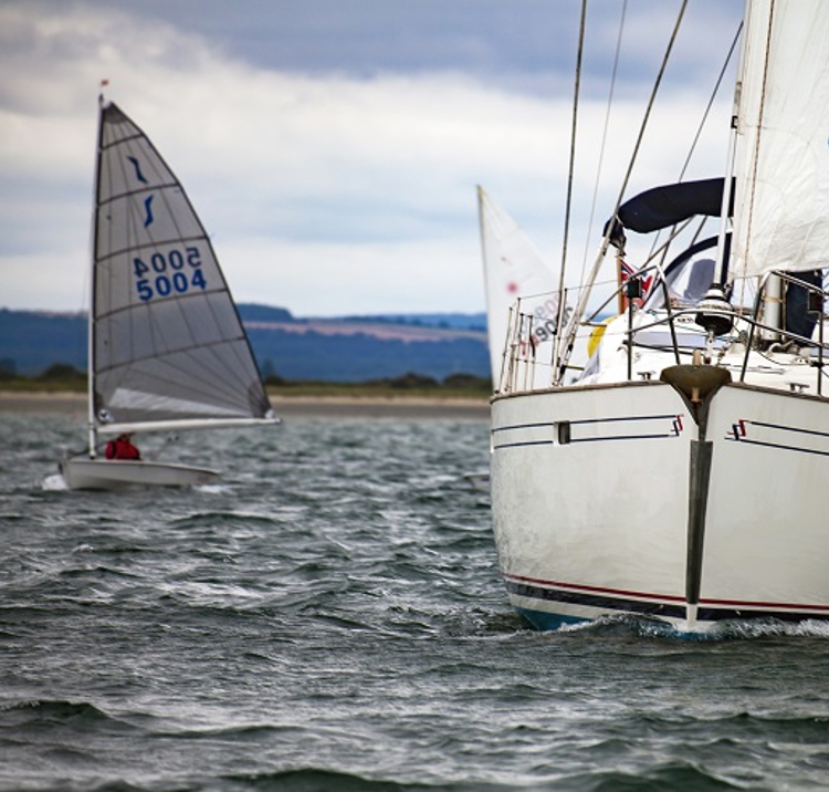 mid shot of yacht sailing with trainees
