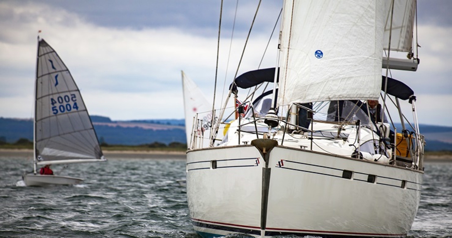 mid shot of yacht sailing with trainees