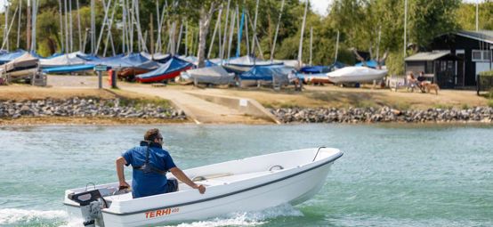 Man on boat in blue waters