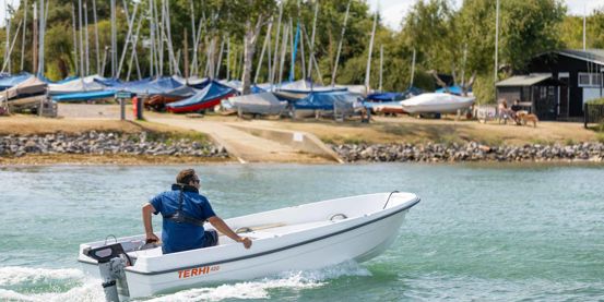 Man on boat in blue waters