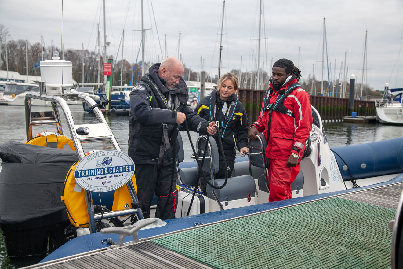 Two people training to use a rib with instructor