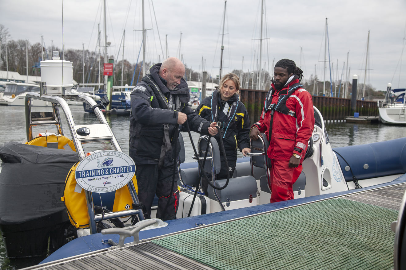 Two people training to use a rib with instructor