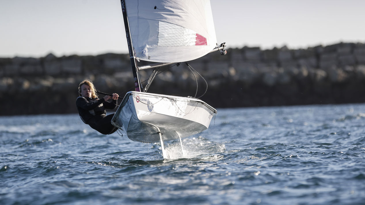 woman on a foiling dinghy during winter