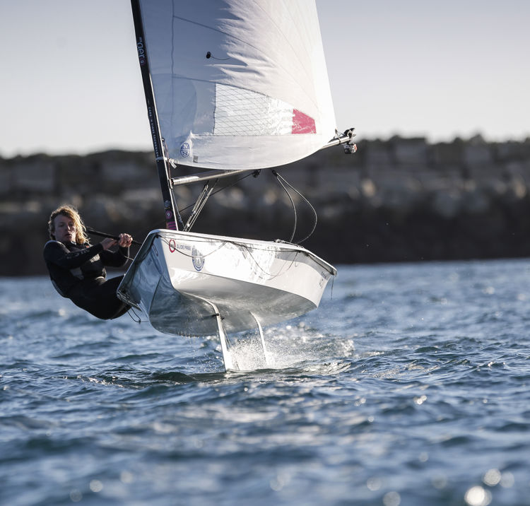 woman on a foiling dinghy during winter