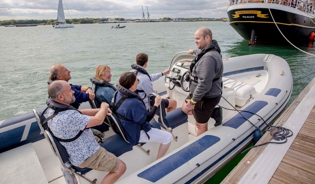 Family trying a RIB at Southampton Boat Show