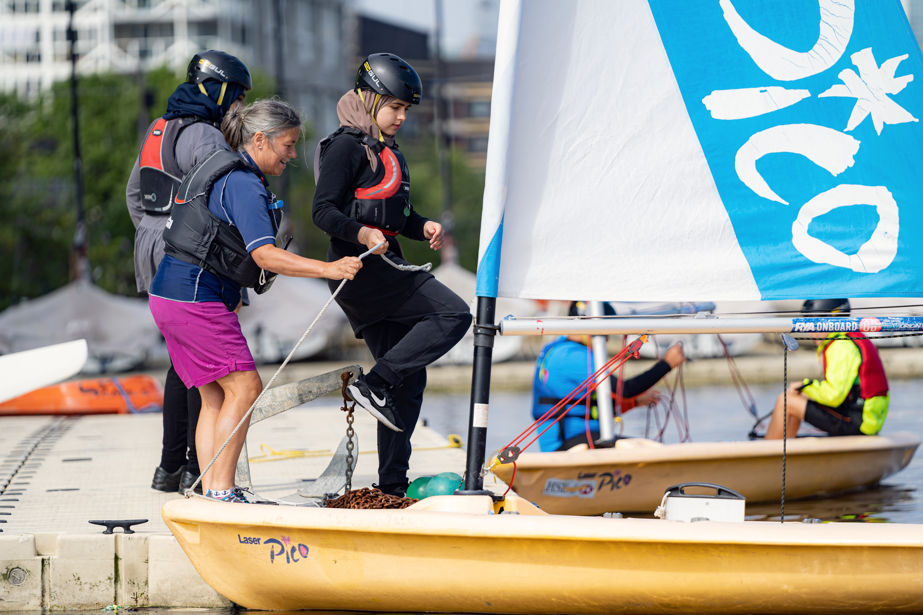 People getting in to a dinghy whilst on shore