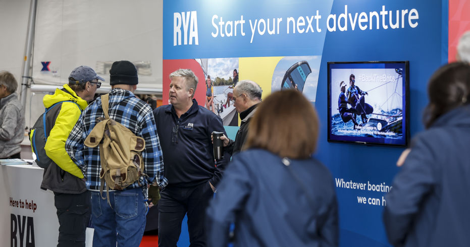 people walking past exhibit at dinghy show
