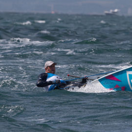 Dinghy sailor travelling through the water