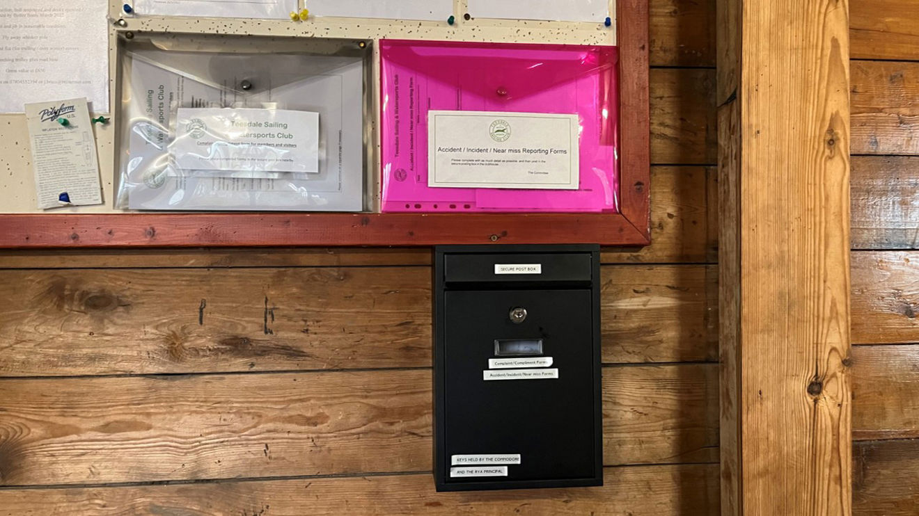Image of a black postbox and safety management forms at Teesdale Sailing & Watersports Club
