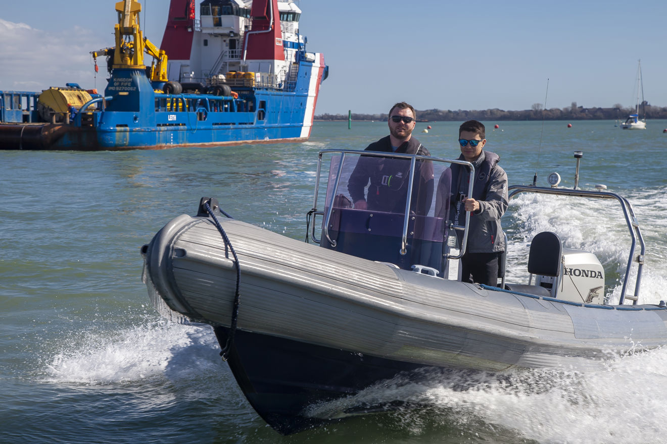 Two men on a rib prevent collision using colregs
