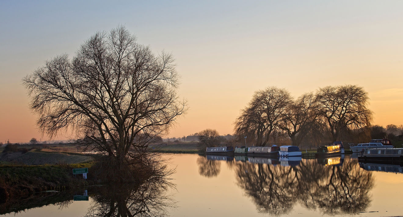 Narrowboats on canal at sunset 