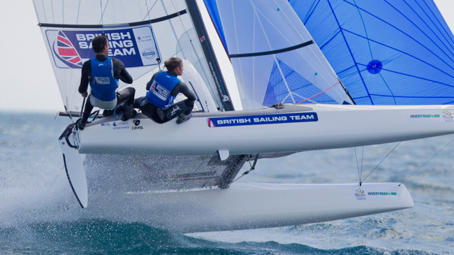 Long shot of man and woman on catamaran