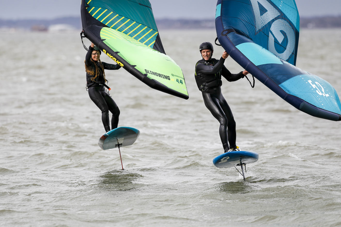 2 people wingsurfing on the open water