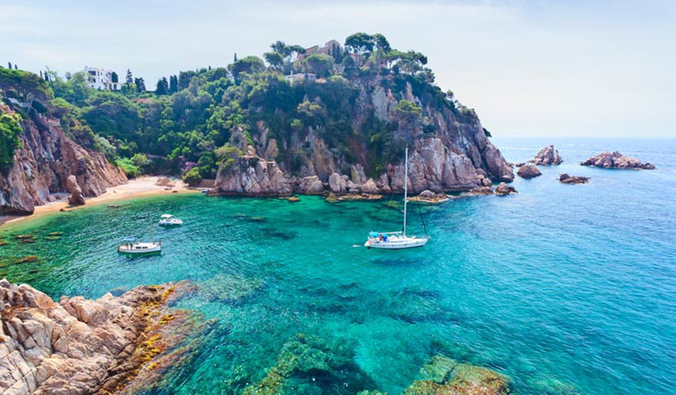 Birdseye shot of boat sailing in Spanish cove