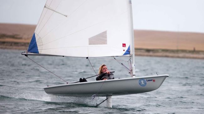 Long shot of woman on sailing dinghy