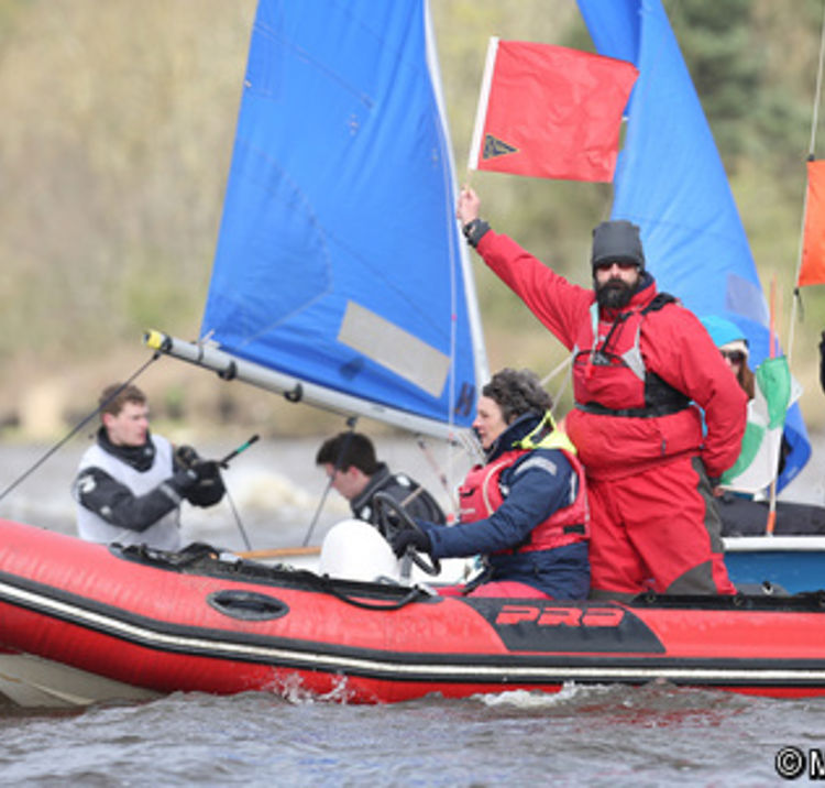 	An umpire displaying a red flag to indicate a penalty