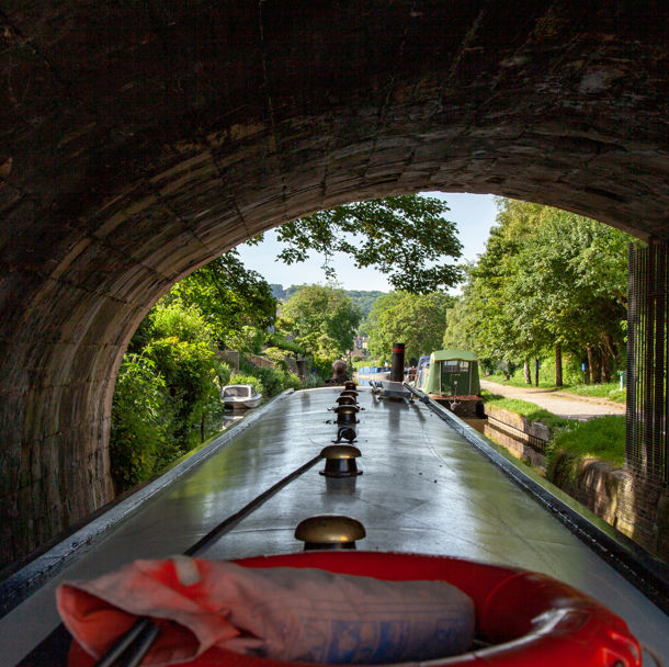 POV shot of canal boat going under bridge