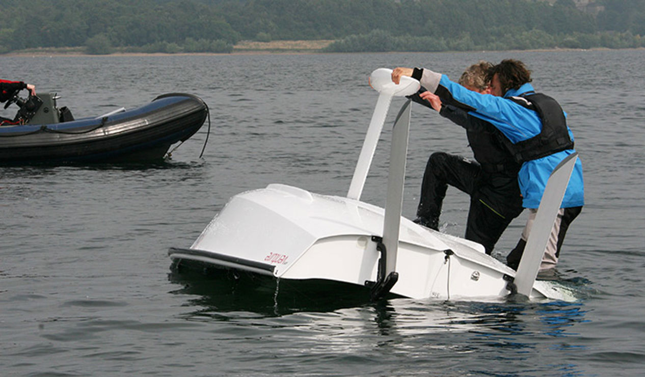 trying to turn over a capsized boat