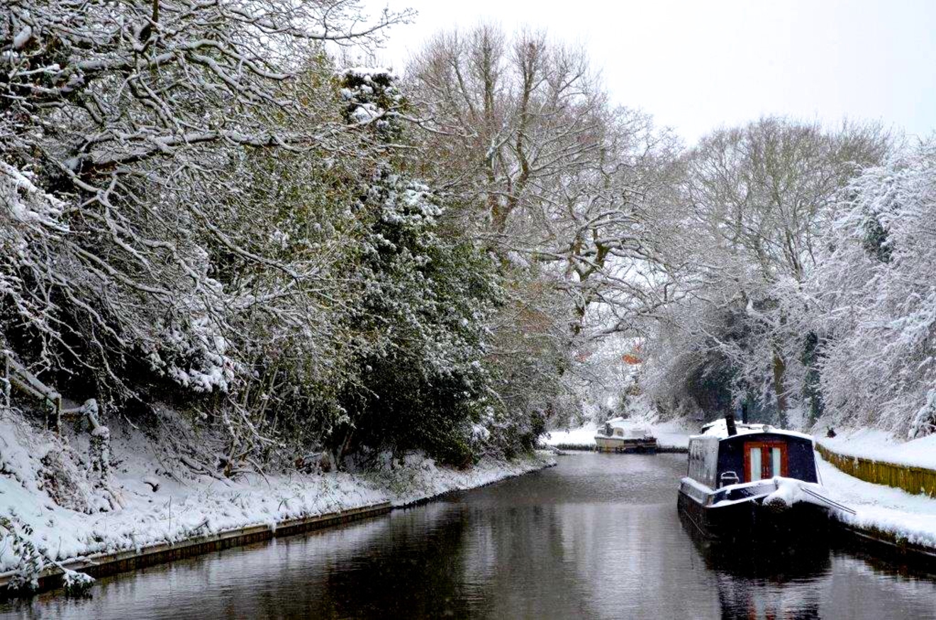 Narrowboat on the canal on a frosty snowy winters day