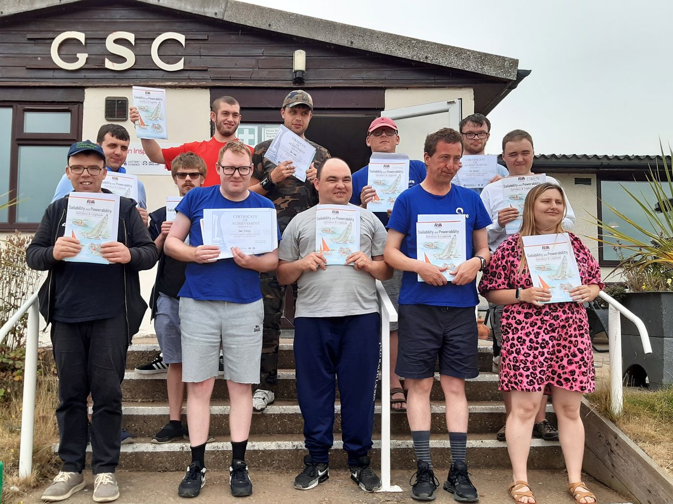 Group of people all looking at the camera, holding certificates.
