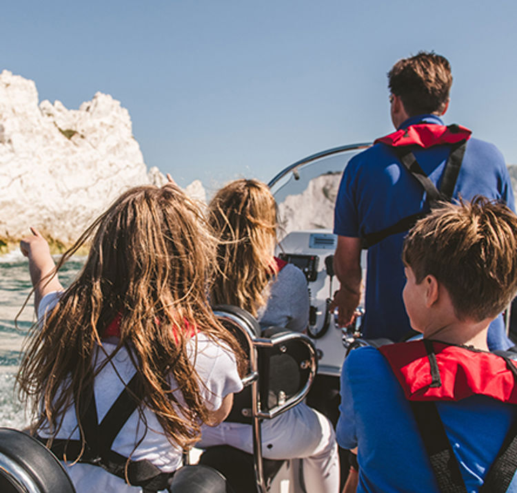 Kids and their instructor on a powerboat