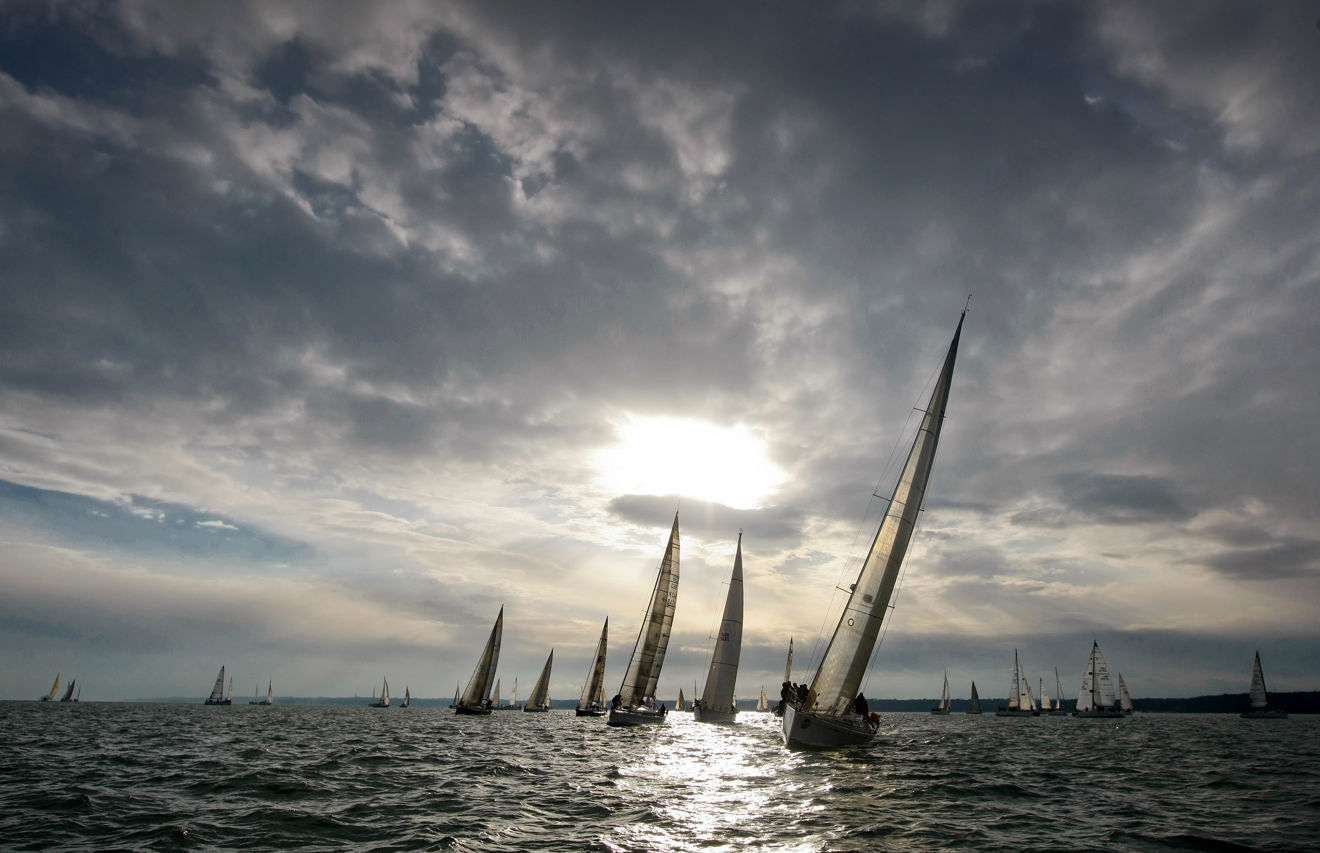 Group of yachts sailing sunset