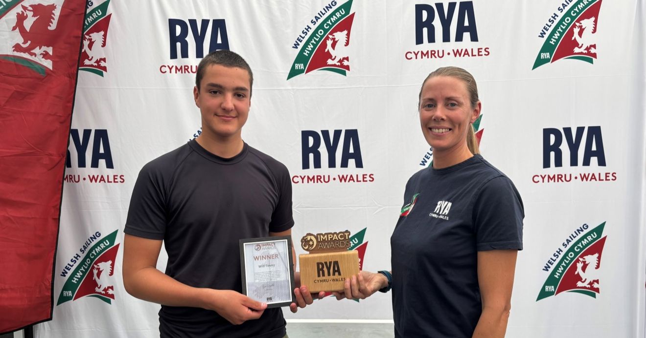 Wilf Tovey is presented with an RYA Cymru Wales Impact Award by Chief Operating Officer Sarah McGovern