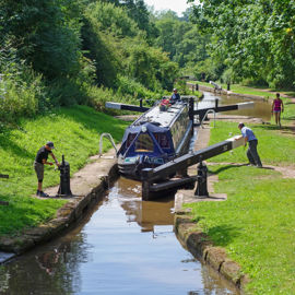 boaters operating a canal lock on the inland waterways 