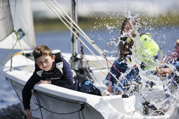 Children on a dinghy splashing water