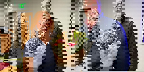 Susan and Gavin at the AGM holding flowers