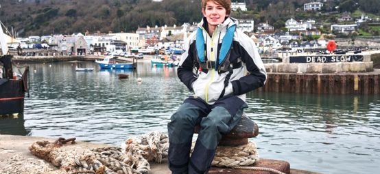 An image of Harry Besley sitting by the shore
