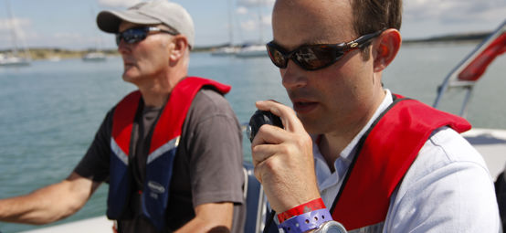 	Man talking through a VHF radio