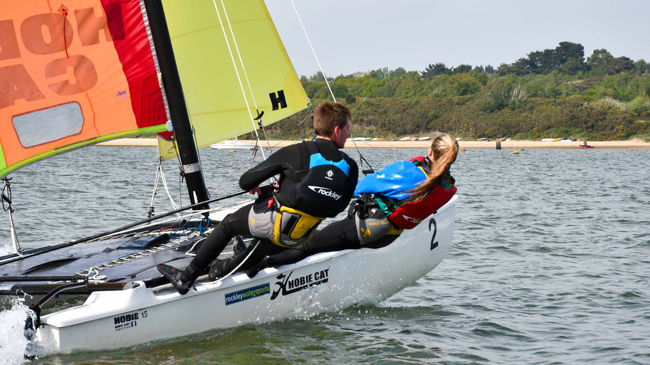 Mid shot of man and woman on double handed dinghy