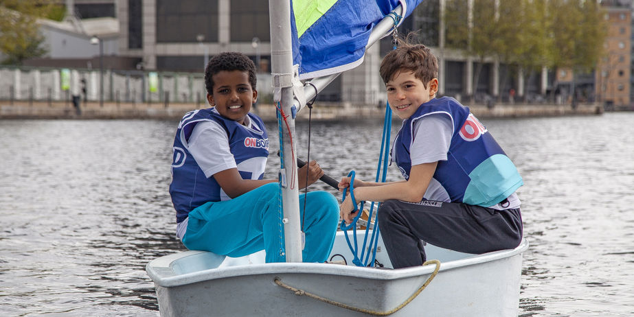 Two young sailors in a training dinghy