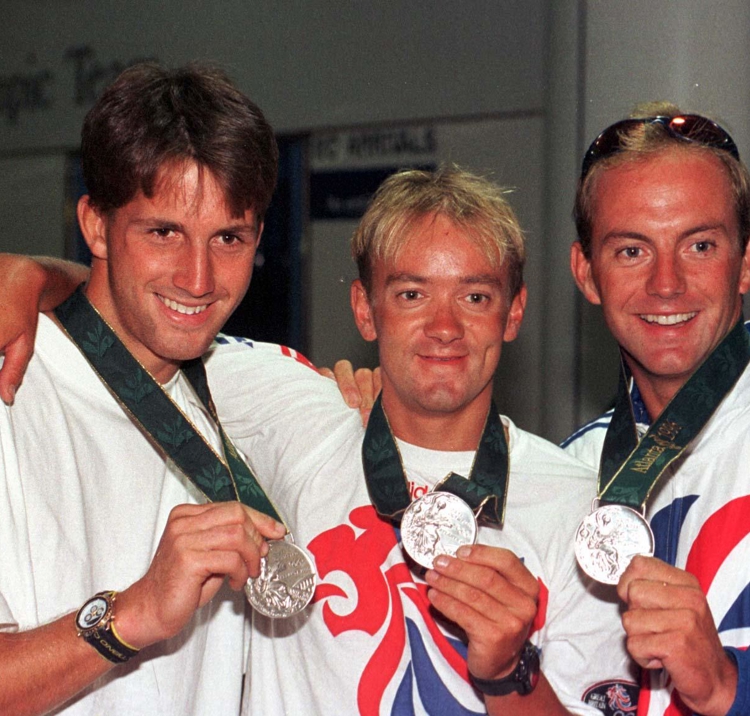Olympic sailors posing with their silver medals