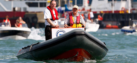 2 people driving a rib