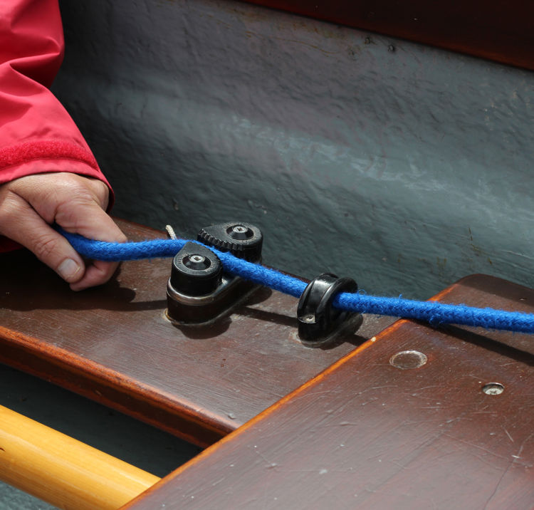 Close up of a hand holding a rope