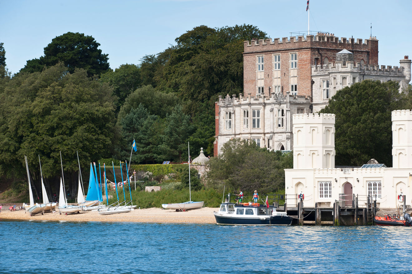 Boats moored along a scenic coastal home