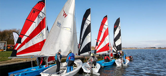 sailors preparing to depart on their dinghies to go sailing