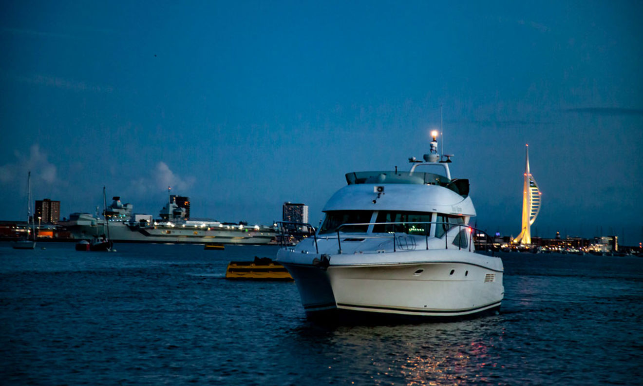 Powerboat sailing at night with navigation lights