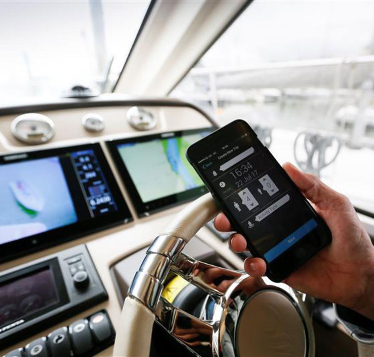 Close up of sailor using their mobile on boat 

