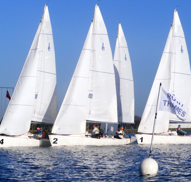 Multiple sail boats navigating familiar waters