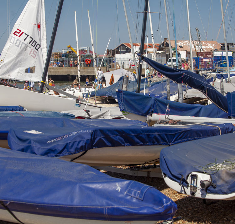 small boats covered in tarp on beach