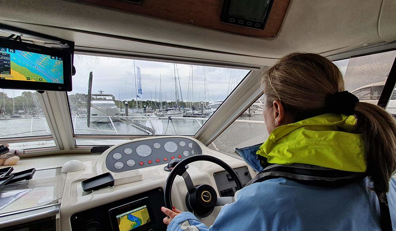 interior shot behind Justine Bowman, she is steering