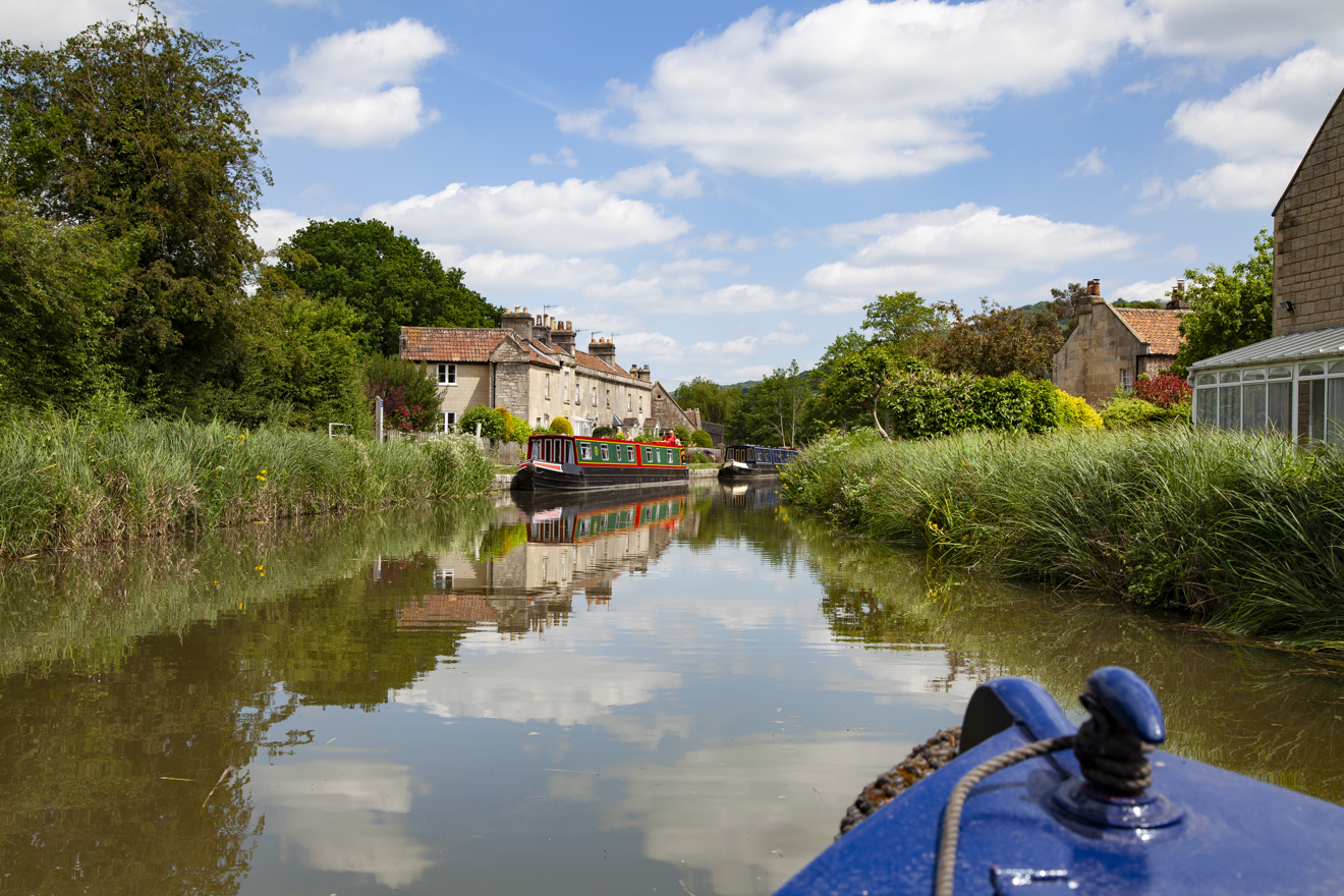 view from the bow of a narrow boat in summer