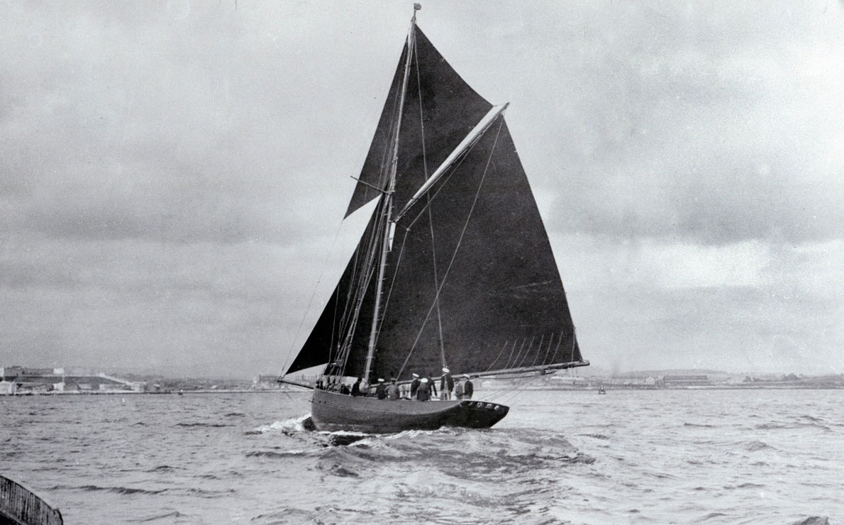 Black and white image of a traditional wooden sail boat