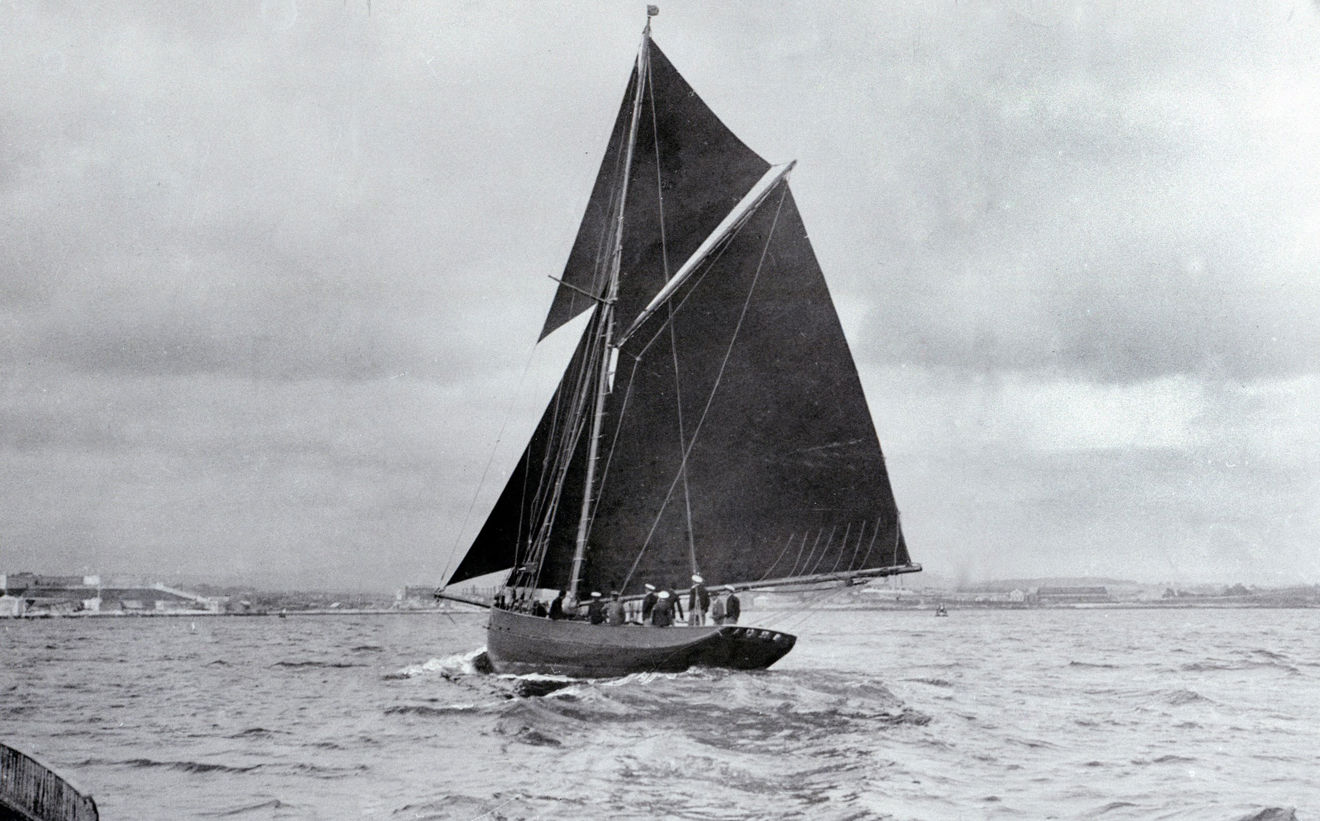 Black and white image of a traditional wooden sail boat